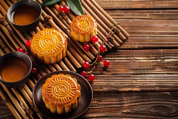中国传统糕点月饼竹制托盘上的茶杯中秋节摄影图