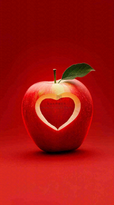 红色苹果掏爱心形状创意平安夜摄影图