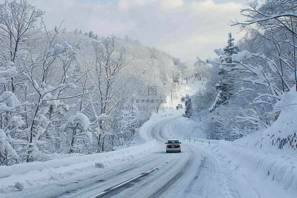 冬天雪山山区公路行驶的汽车白雪覆盖寒冷摄影图