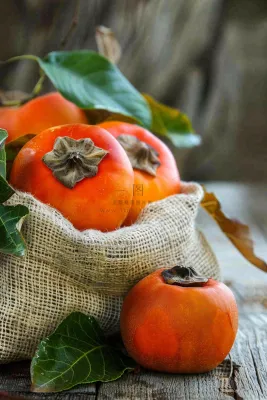 金黄成熟柿子水果秋天丰收秋分立秋摄影图