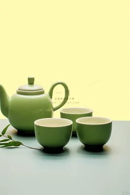 绿色茶壶茶杯植物浅绿背景墙摄影图