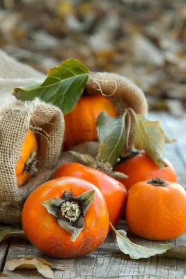 金黄成熟柿子水果秋天丰收秋分立秋摄影图