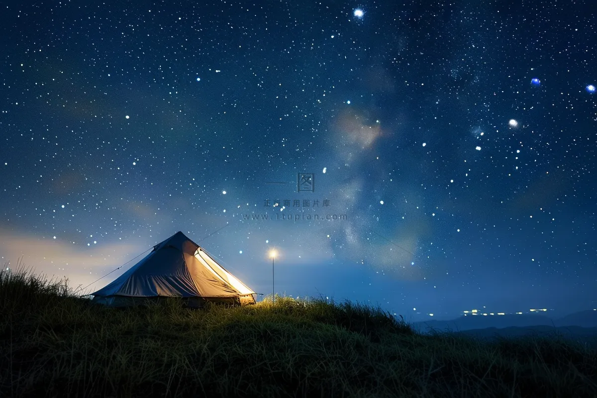 野外露营星空夜晚山顶的帐篷摄影图