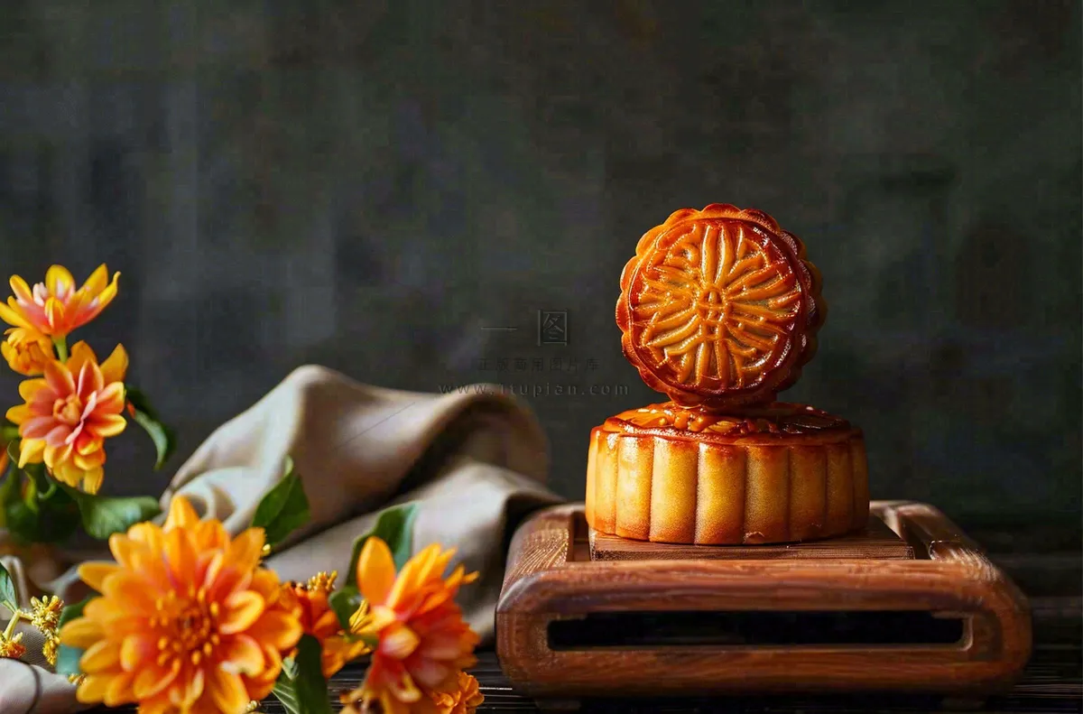 中国传统美食月饼中秋节菊花摆盘黑色背景摄影图
