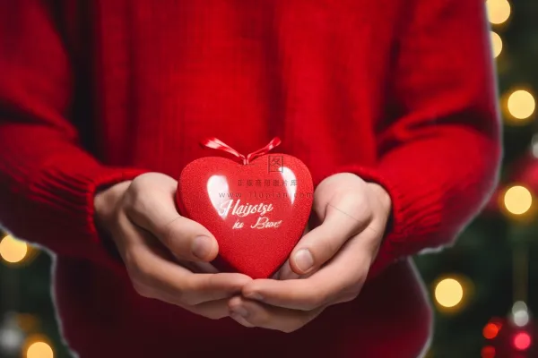 男孩手捧红色爱心礼盒摄影图