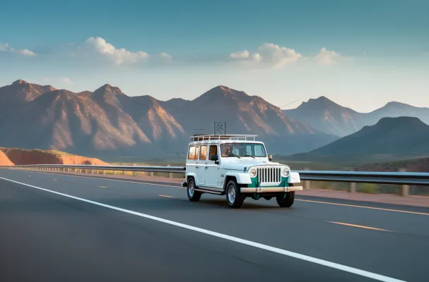 白色汽车在高速公路上行驶旁边是远处的雪山摄影图